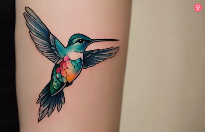 A hummingbird tattoo on a woman’s forearm