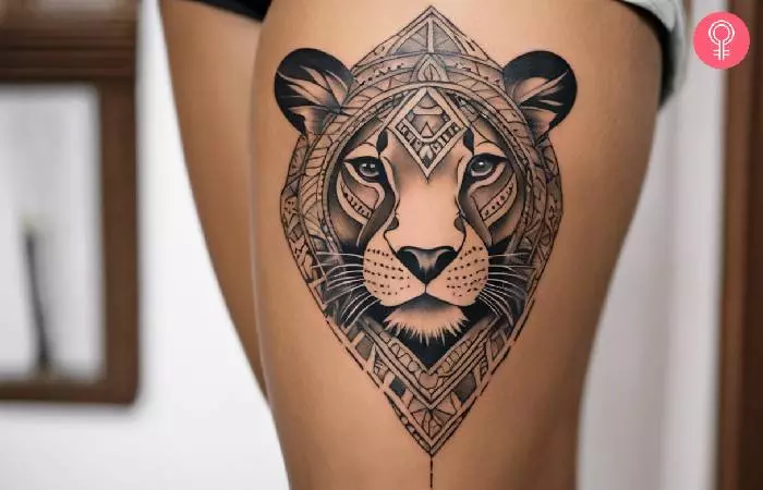 A lioness thigh tattoo for women