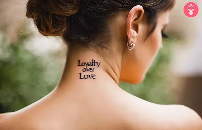 A loyalty over love tattoo on a woman’s nape