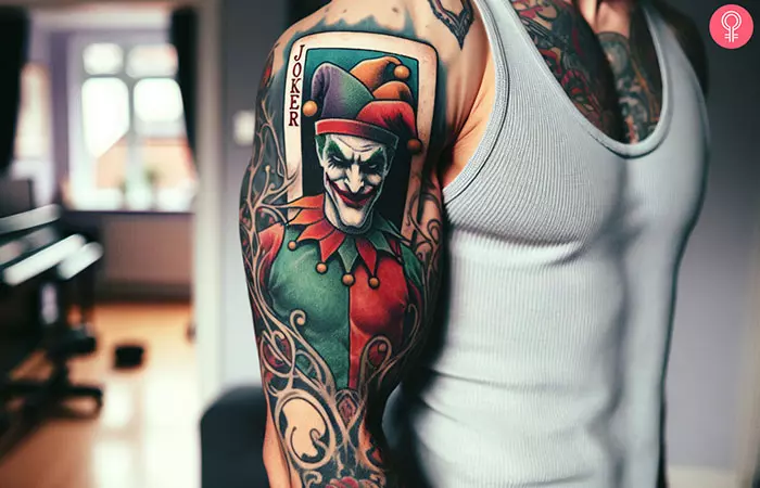 A man sporting a Joker card tattoo on his biceps