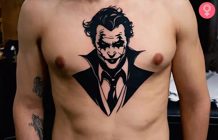 A man with a Joker chest tattoo