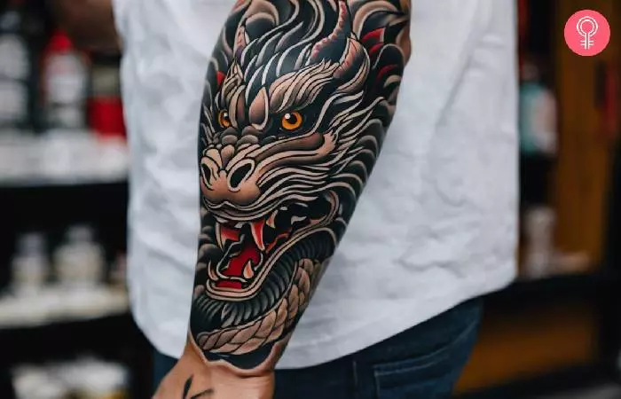 A man with a Tebori dragon tattoo design on his forearm