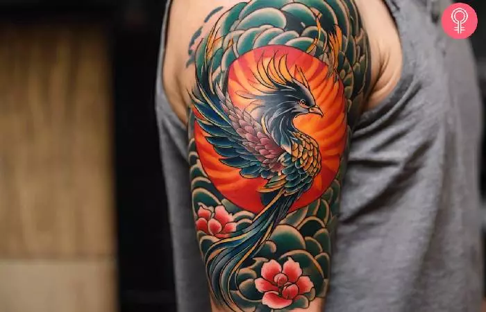 A man with a Tebori phoenix tattoo design on his upper arm