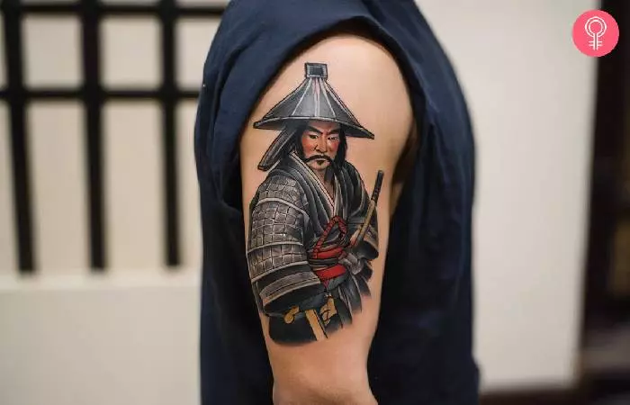 A man with a Tebori samurai tattoo design on his upper arm