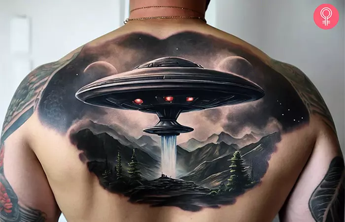 A man with a UFO alien tattoo on his back