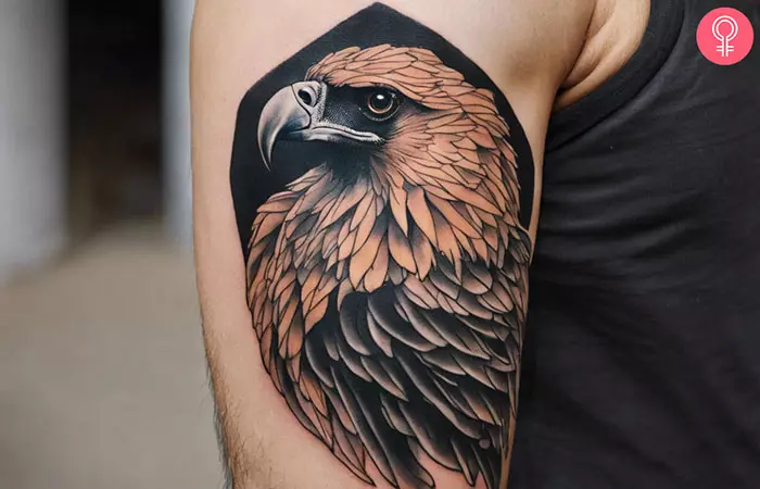 A man with a bearded vulture tattoo on the upper arm