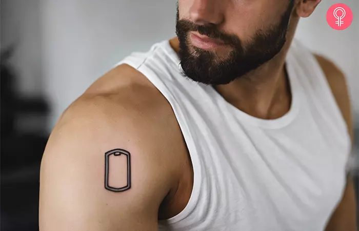 A man with a dog tag outline tattoo