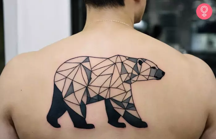 A man with a geometric polar bear tattoo on the back
