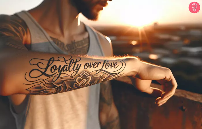 A man with a half-sleeve loyalty over love tattoo