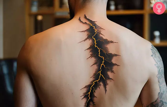 A man with a lightning strike tattoo on his back