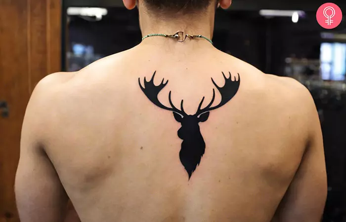A man with a moose antler tattoo on the back