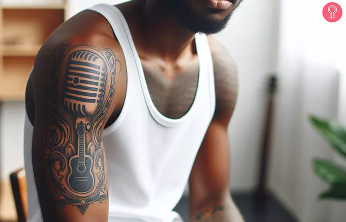 A man with a studio microphone tattoo on his upper arm
