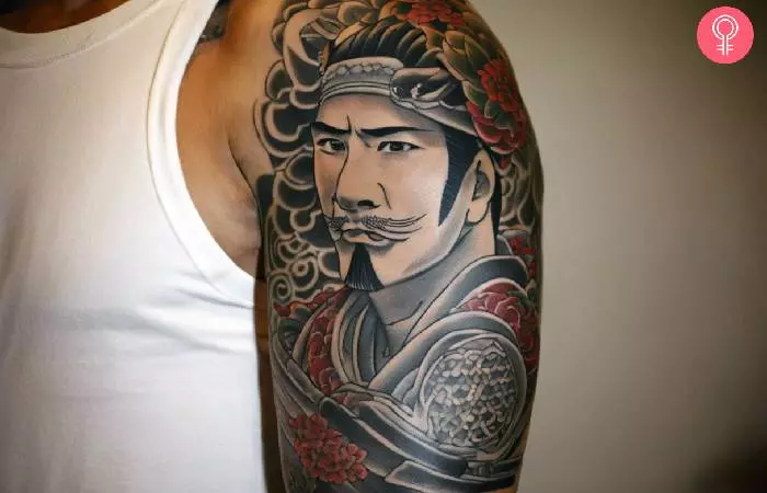 A man with a yakuza Tebori tattoo design on his upper arm
