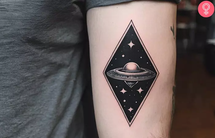 A man with an alien spaceship tattoo on his upper arm