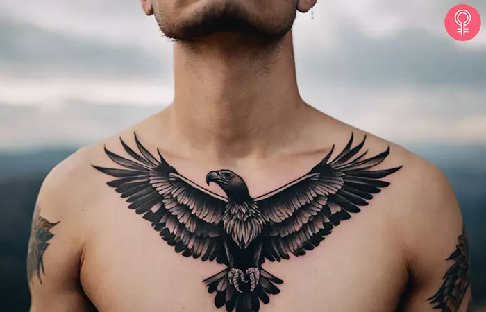 A man with an open-winged, black-and-gray vulture tattoo on the chest