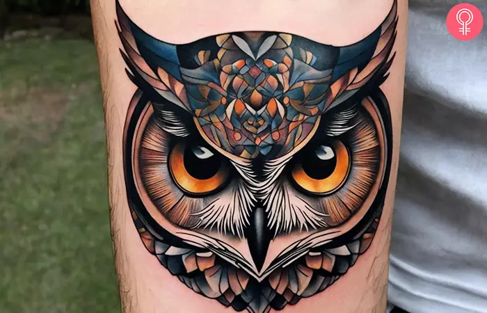 A man with an owl eyes tattoo on his forearm