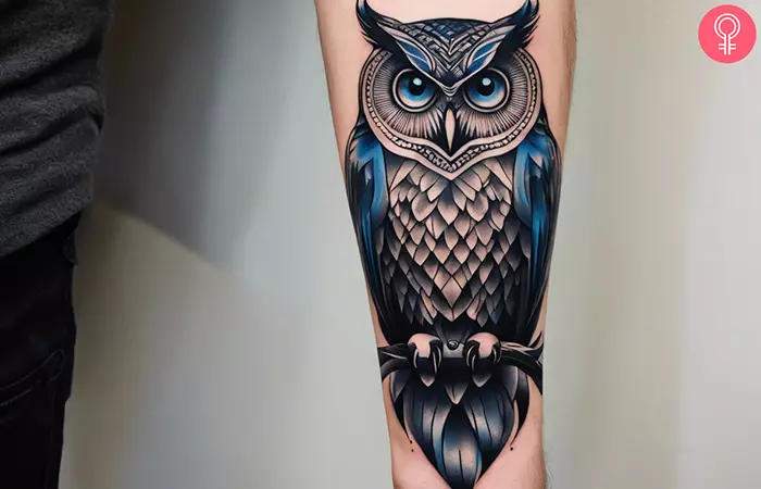 A man with an owl tattoo on his forearm
