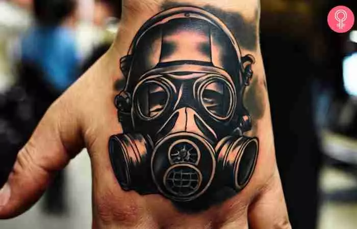 A military tattoo of a gas mask on the back of a man’s hand