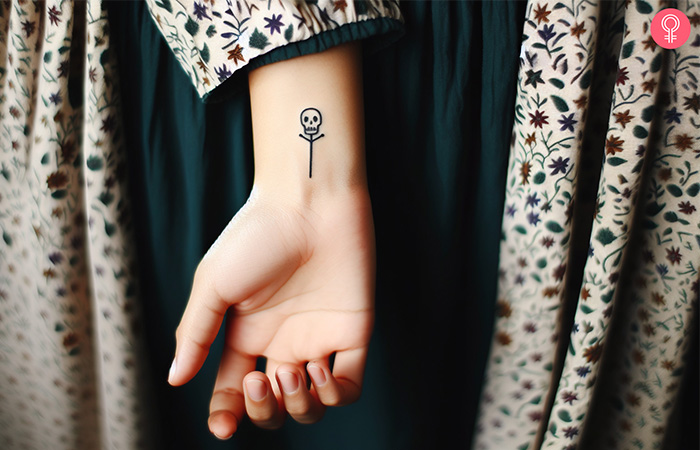 A minimalist memento mori tattoo on a woman’s wrist