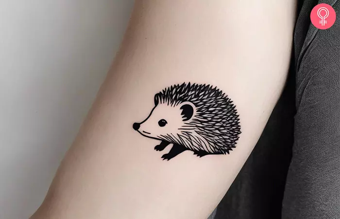 A minimalistic hedgehog tattoo on the inner arm