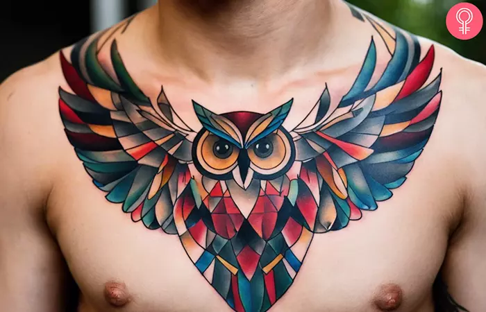 A multicolored geometric owl tattoo on a man’s chest