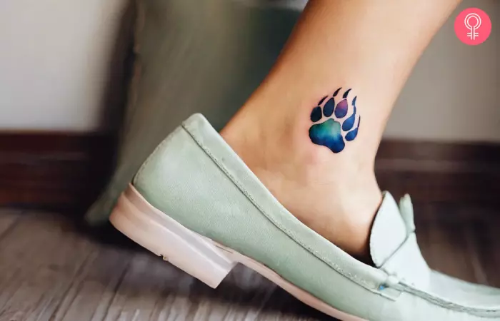 A polar bear paw tattoo on the ankle