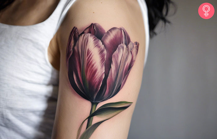 A realistic tulip tattoo on the upper arm