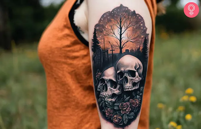 A skull graveyard tattoo on the upper arm