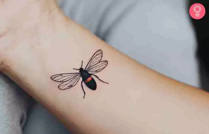 A small insect tattoo on a woman’s wrist