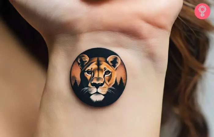 A small lioness tattoo on the wrist