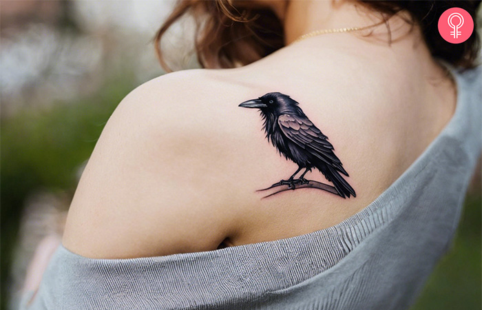 A small raven tattoo on the shoulder blade
