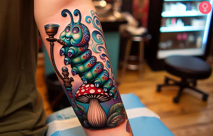 A smoking caterpillar tattoo on a woman’s forearm