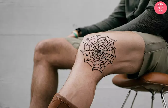 A spider web tattoo on the knee