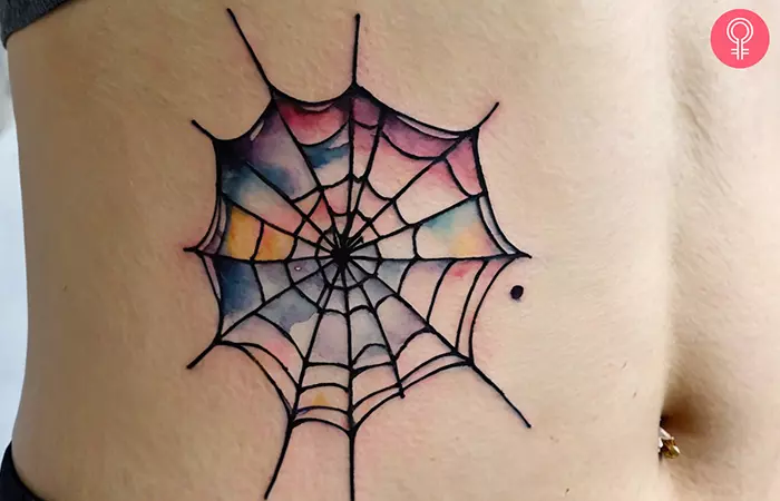 A spider web tattoo on the stomach