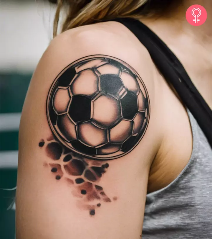 A stylish soccer tattoo on the arm of a woman