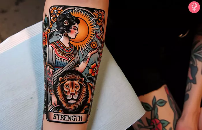 A tarot card tattoo of a woman embracing a lion