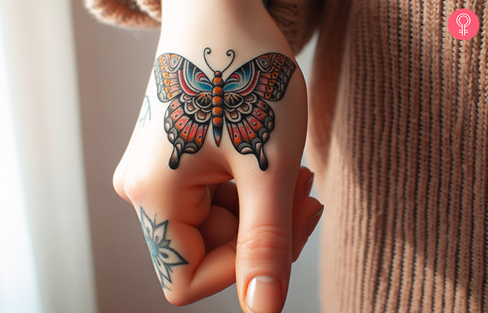 A traditional thumb tattoo of a butterfly