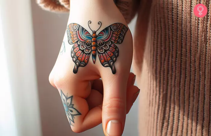 A traditional thumb tattoo of a butterfly