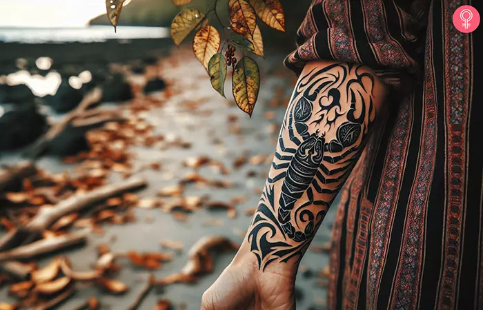 A tribal tattoo of a scorpion on the forearm