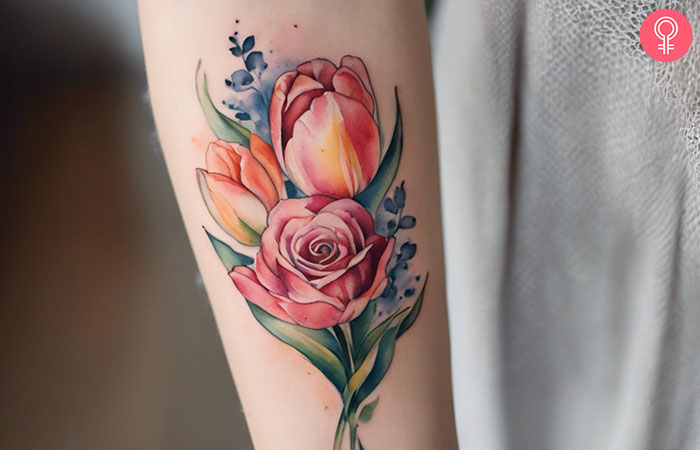 A tulip and rose tattoo on the forearm