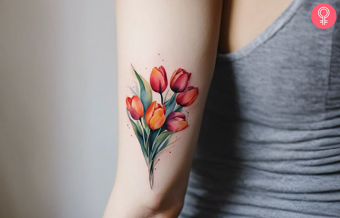 A tulip bouquet tattoo on the back of the arm