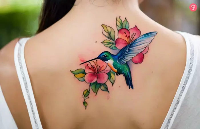 A watercolor hummingbird tattoo on the back