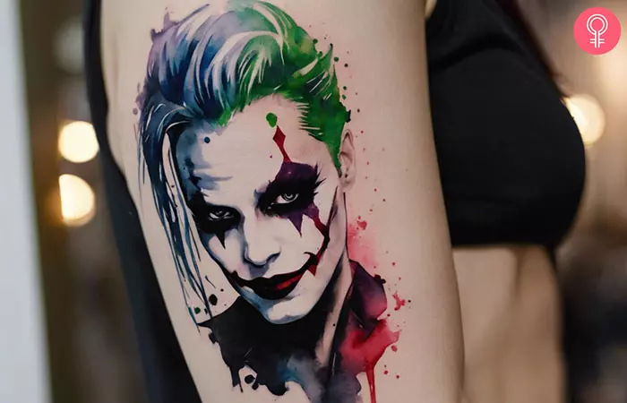 A woman showcasing a suicide squad joker tattoo on her arm