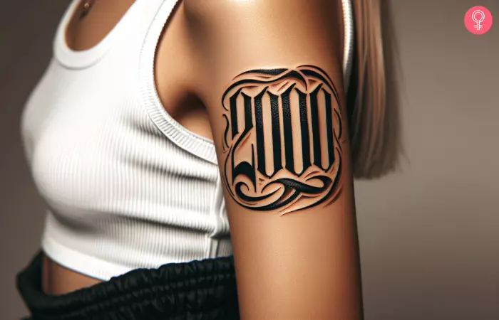 A woman with a 2000 gothic font tattoo on her upper arm