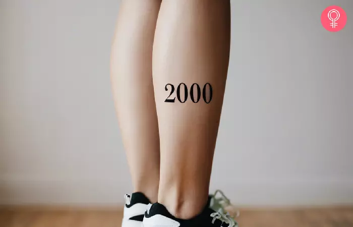 A woman with a 2000 tattoo on her leg