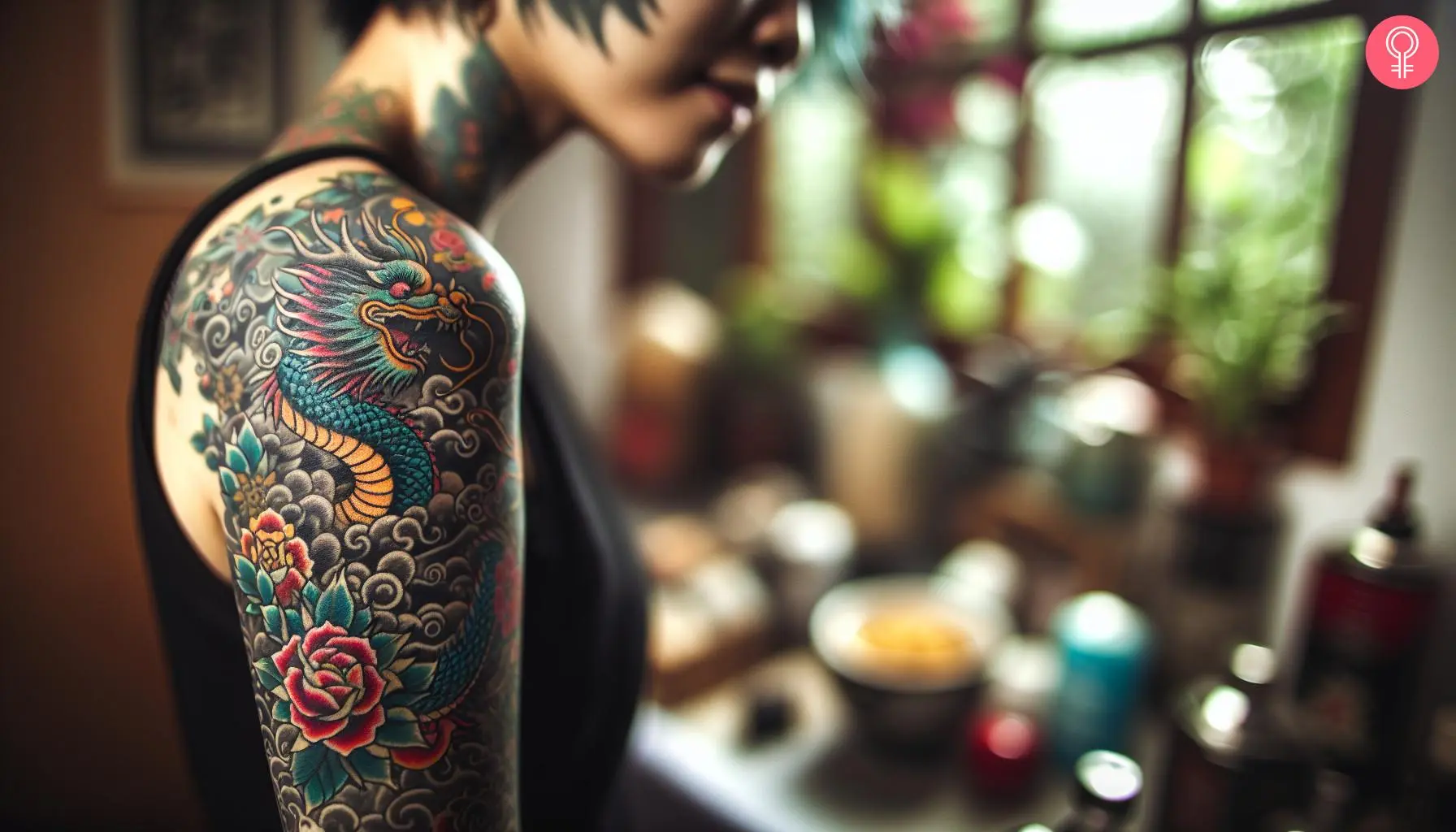 A woman with a Japanese dragon and flowers tattooed on her upper arm