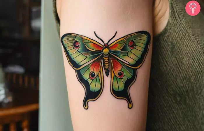 A woman with a Spanish moon moth tattoo on her arm