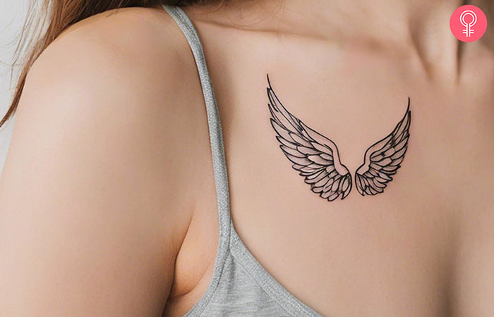 A woman with a baby angel wings tattoo on her upper chest