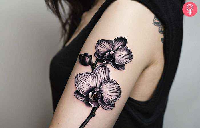 A woman with a back orchid tattoo on her wrist