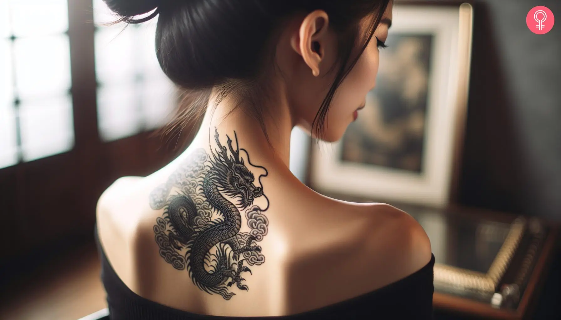 A woman with a black and gray Japanese dragon tattoo on her upper back